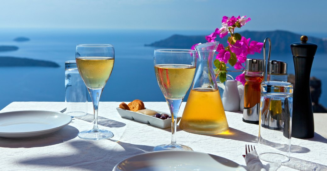 table set for two in cliff-side restaurant in Mykonos, Greece