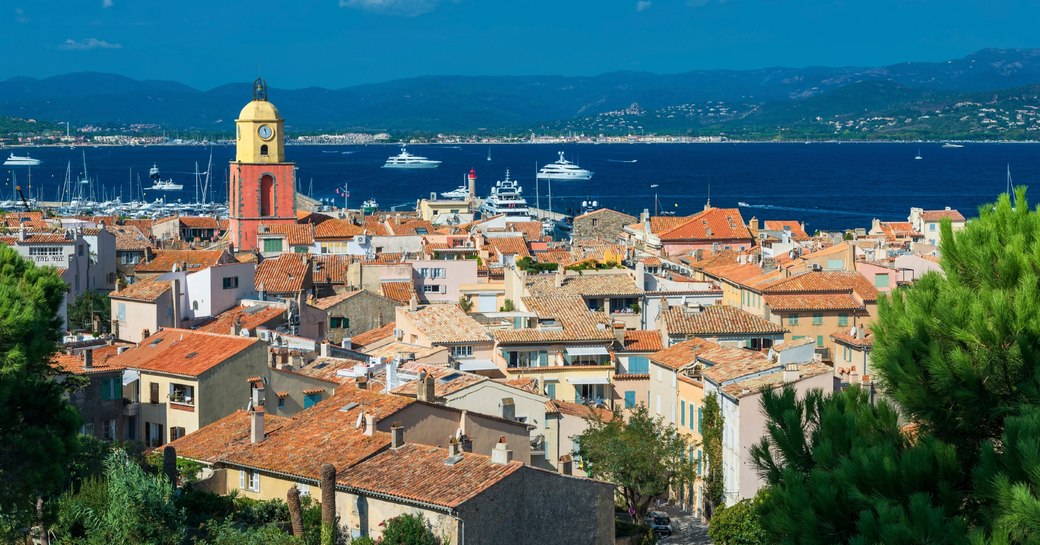 view over the red roofed buildings of St Tropez and across the bay