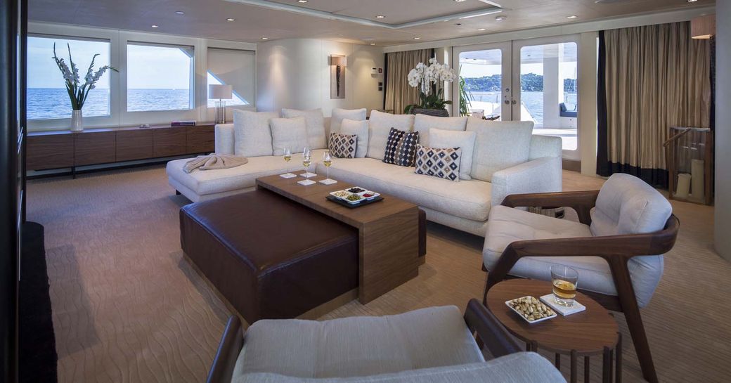 sumptuous sofa and armchairs form a salon in the interior of superyacht Big Sky 
