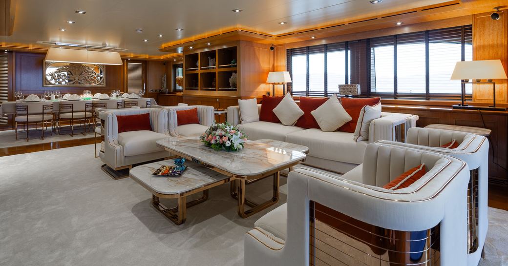 Overview of the main salon with a plush lounge area onboard charter yacht LADY I