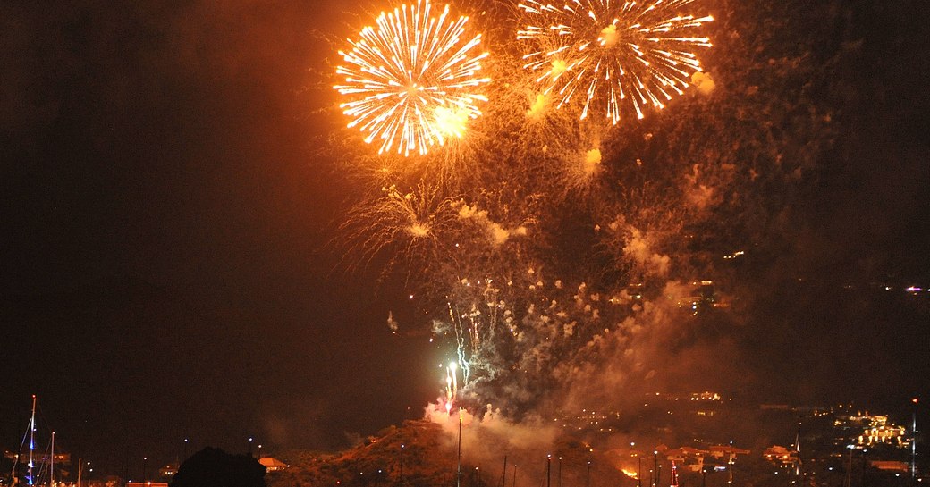 Overview of orange fireworks during the St Barts New Year's Eve celebrations