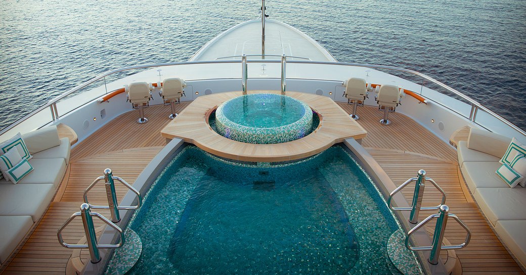 Overview of the swimming pool and Jacuzzi on the sun deck onboard charter yacht WHISPER