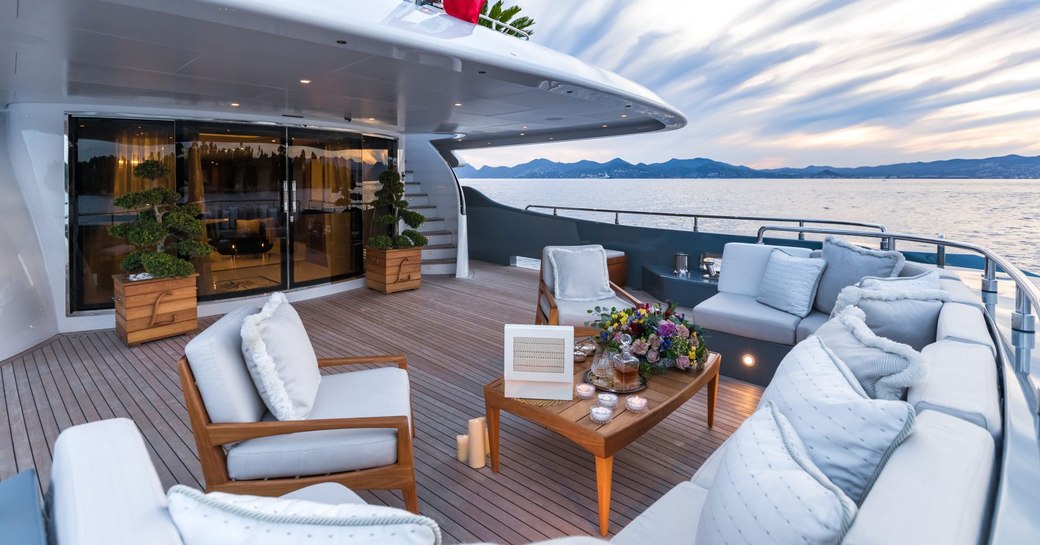 The alfresco dining and lounging area on the exterior of motor yacht LEGENDA