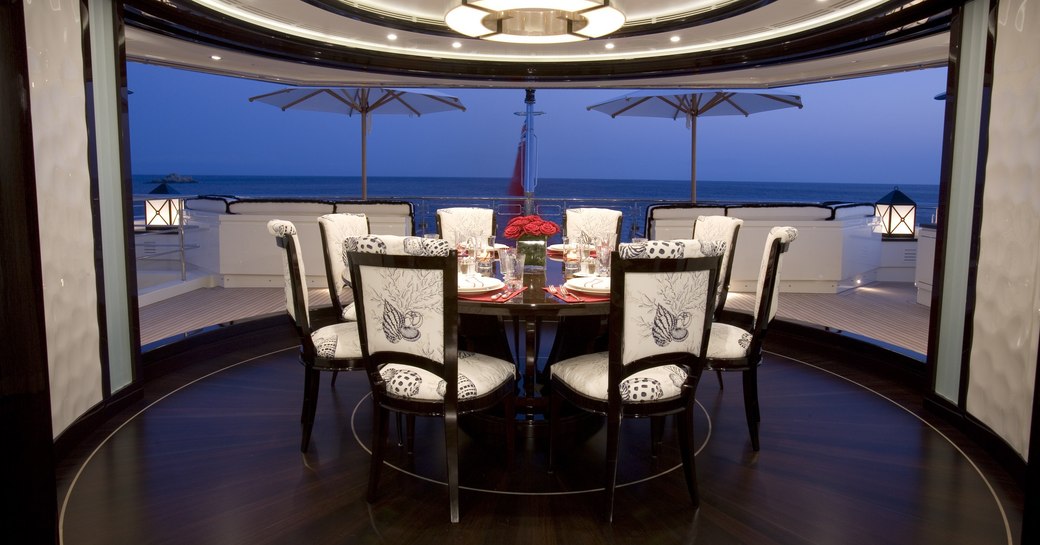 circular dinning area with full-length revolving glass doors on board superyacht Alfa Nero