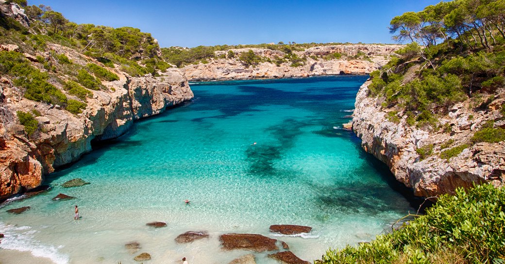 pretty bay in ibiza with clear blue sea