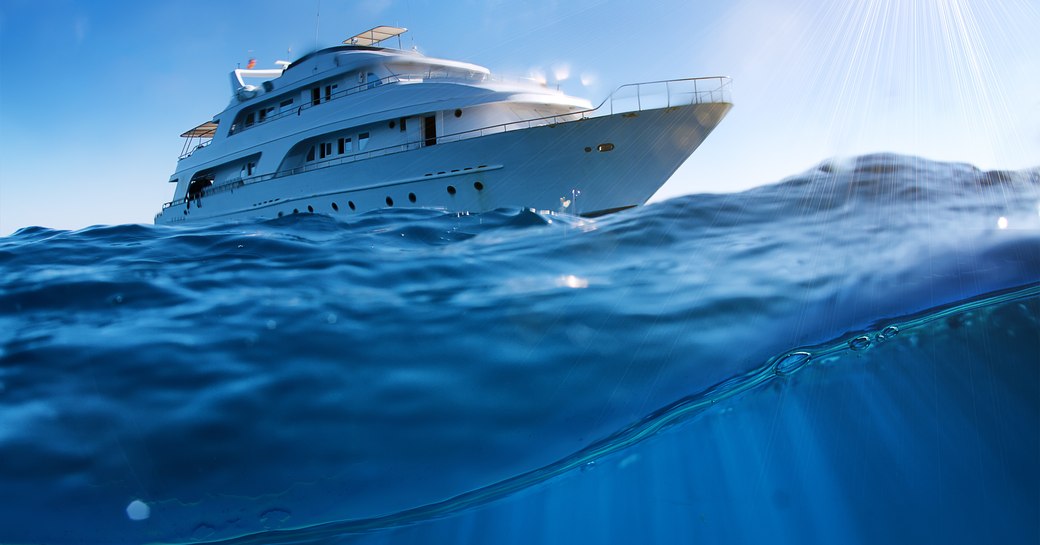 A dolphin under the swell of a yacht