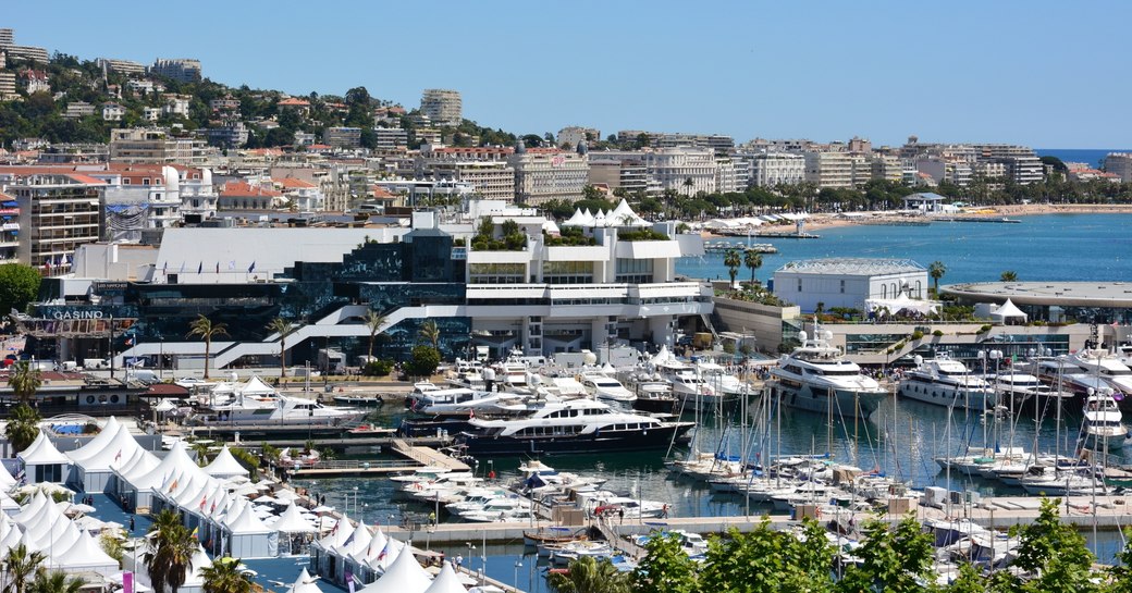 superyachts berthed in the Old Port, Cannes, with Palais des Festivals in background