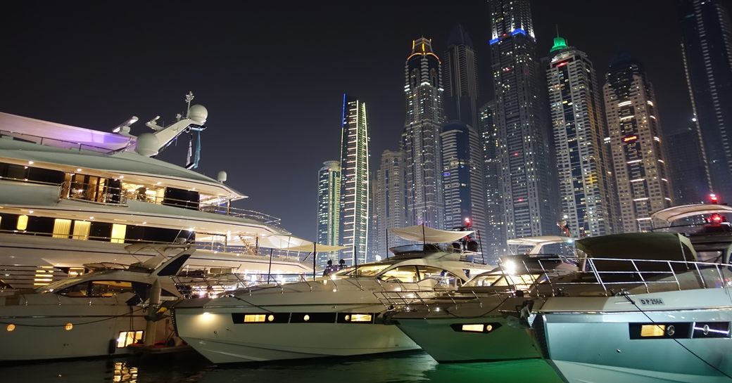 yachts lined up at night for the Dubai International Boat Show 