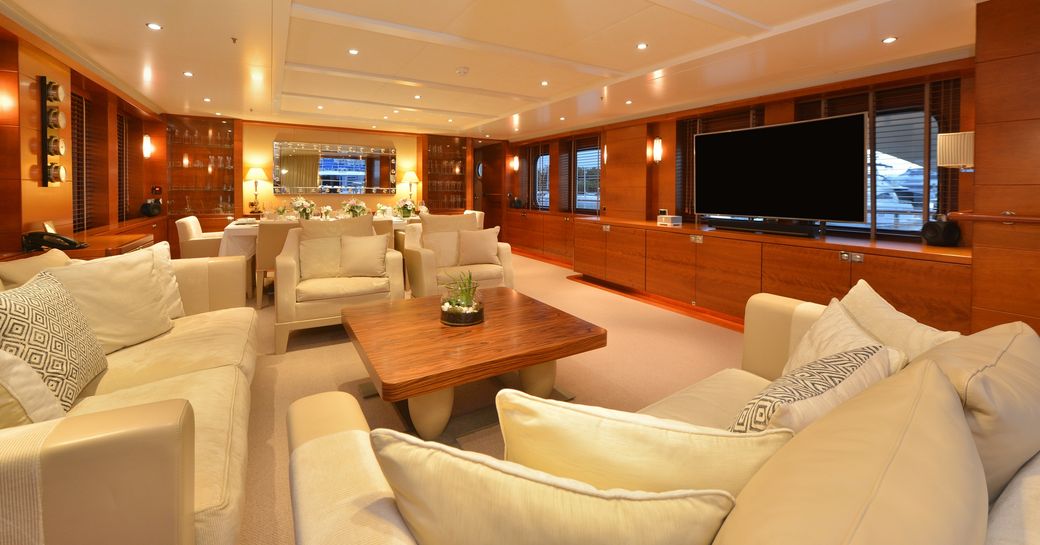 sumptuous seating forms a lounge area with a TV in the main salon of superyacht BELUGA