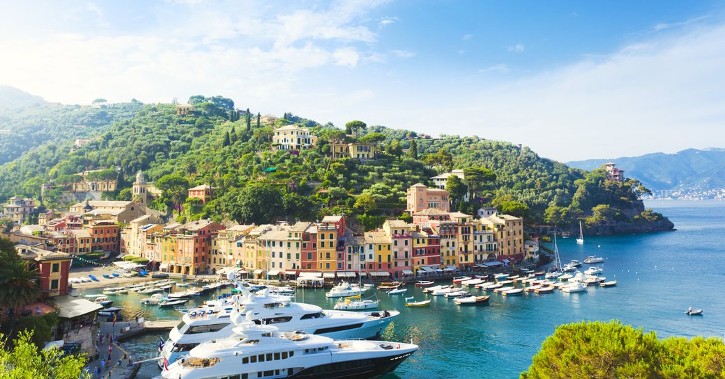 superyacht marina in portofino, with luxury yachts and bright buildings