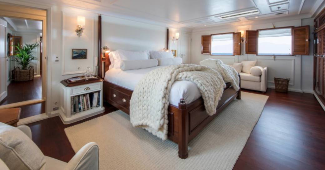 master suite with rich wooden accents and skylight on board superyacht Haida 1929