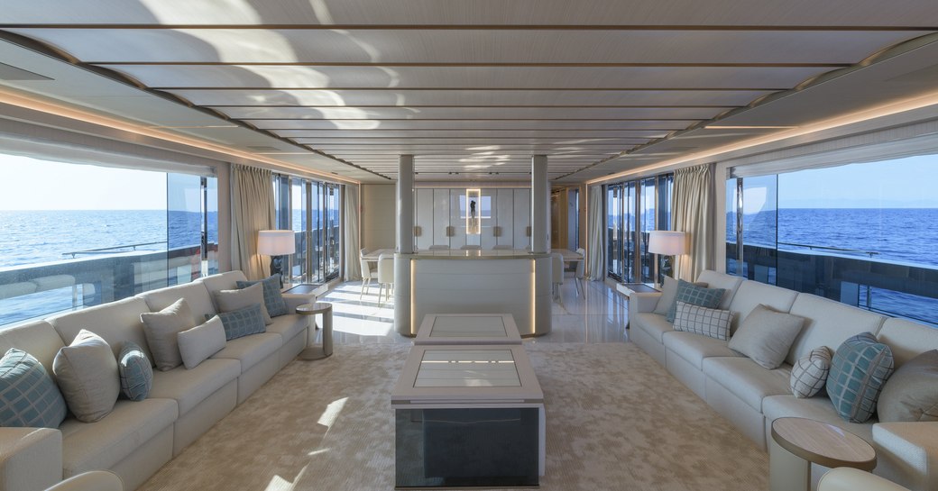 Light filled interior on superyacht EIV with sofas and table