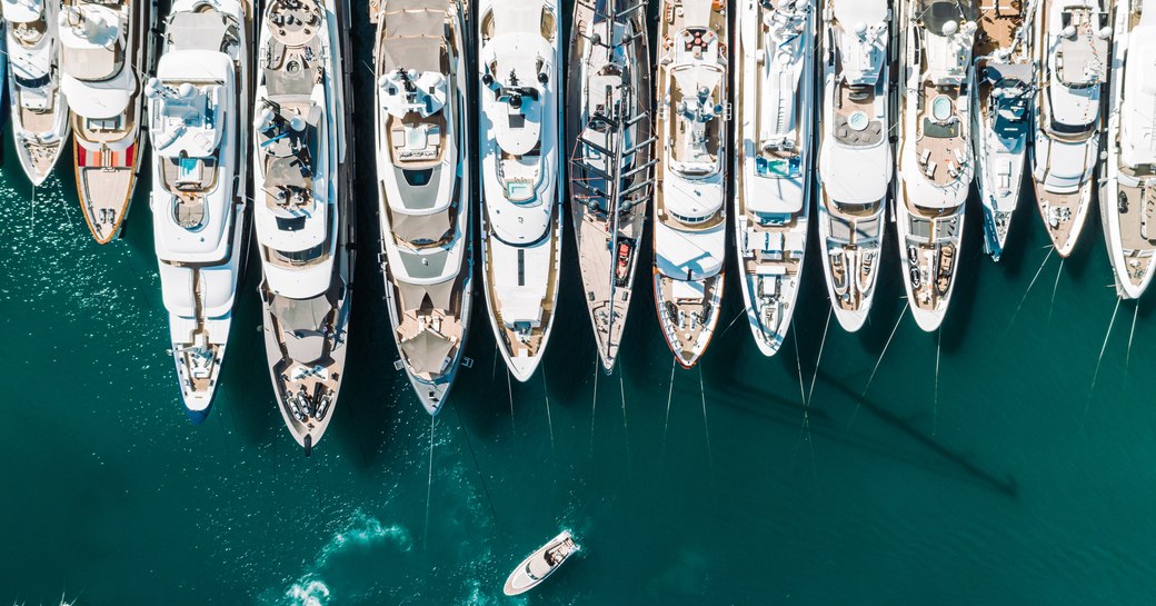 Aerial view of line of superyachts moored at Monaco Yacht Show.