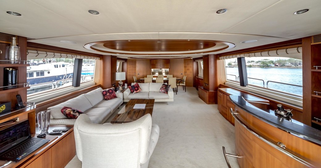 warm woods and neutral furnishings of the main salon aboard luxury yacht Antonia II 