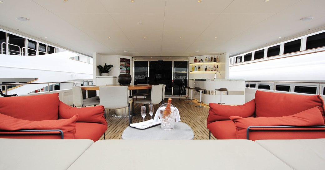 seating, dining area and bar on the aft deck of motor yacht My Eden