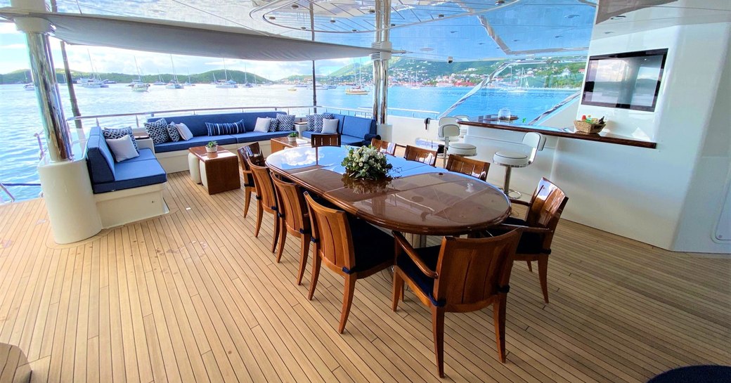 Shaded dining table on superyacht Chasing Daylight