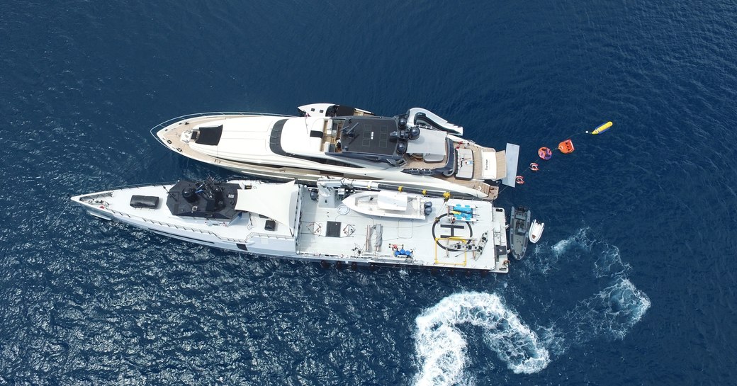 Overhead view of superyacht Vantage and support vessel Ad-Vantage side-by-side with water toys