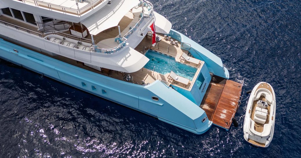 Swim platform and adjacent tender of charter yacht AXIOMA