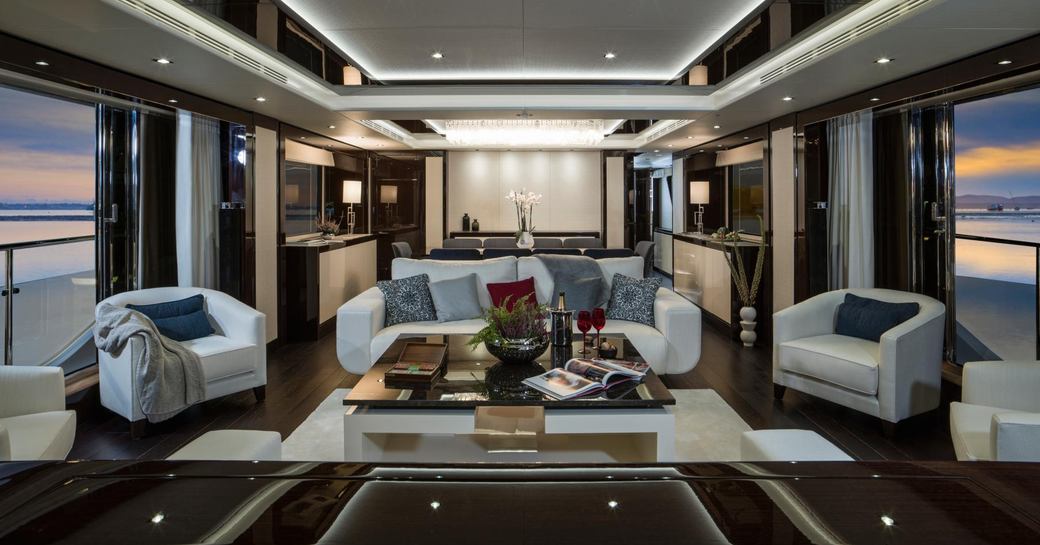 modern main salon with floor-to-ceiling windows aboard charter yacht FLEUR
