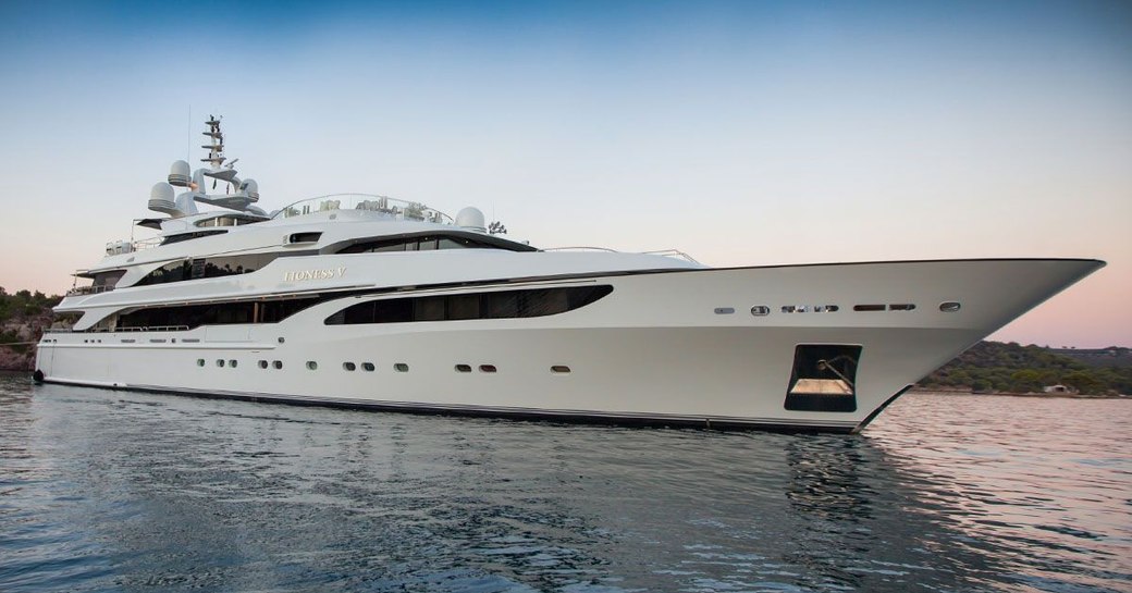 Charter yacht 'Lioness V' underway, surrounded by sea at dusk