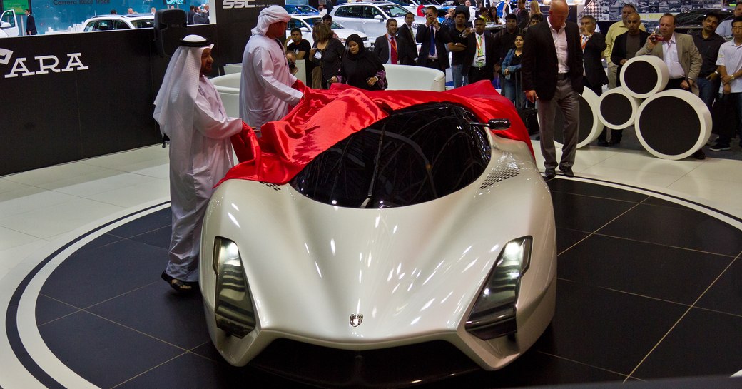 Arab men looking at supercar