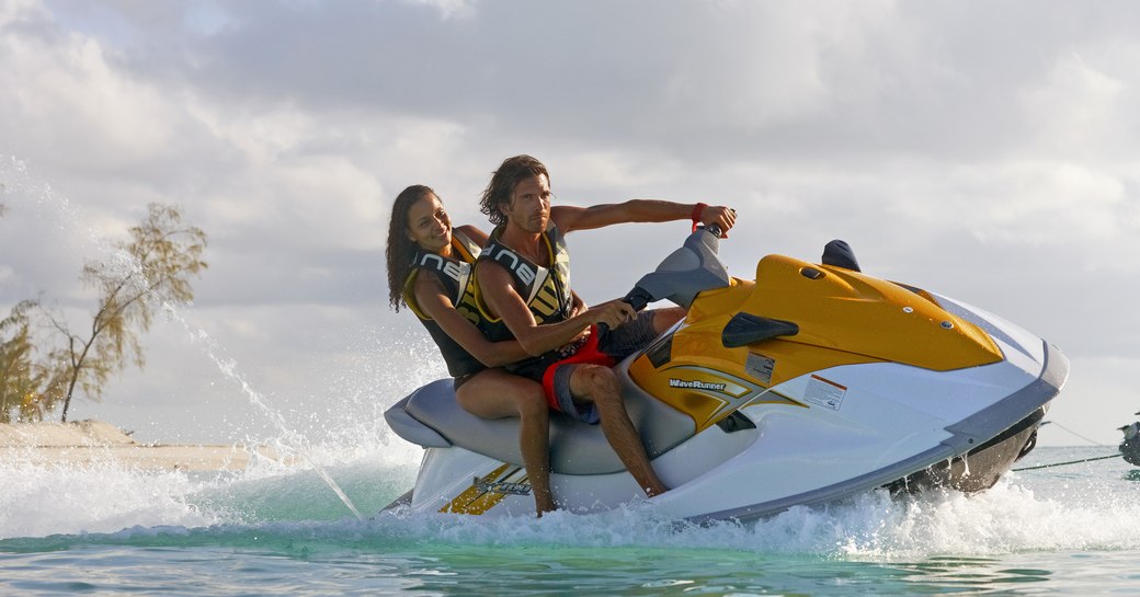 people riding jet-skis in the water around thanda island