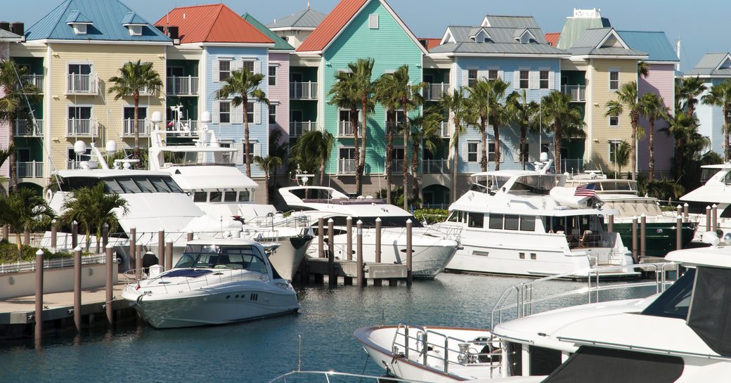 A marina in the Bahamas with several motor yachts berthed