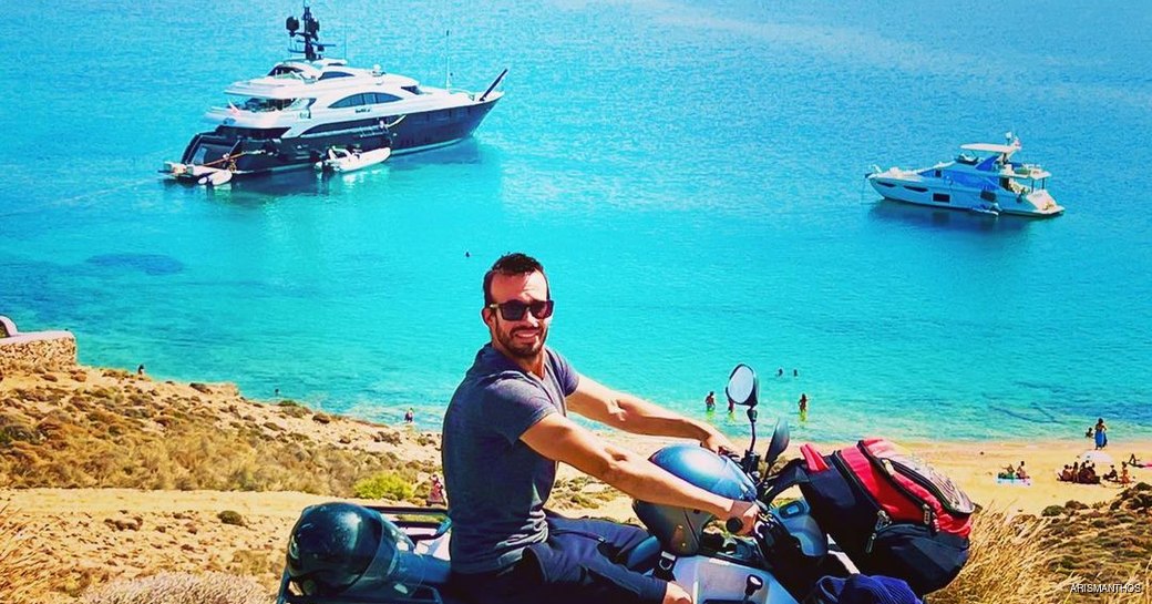 man exploring behing Agios sostis beach, Mykonos