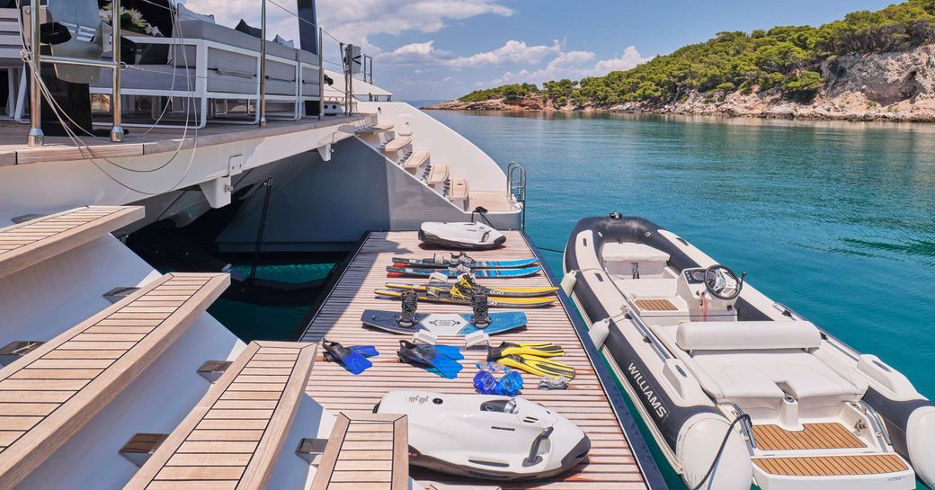 Swim platform onboard charter yacht ABOVE & BEYOND and tender adjacent in the water 