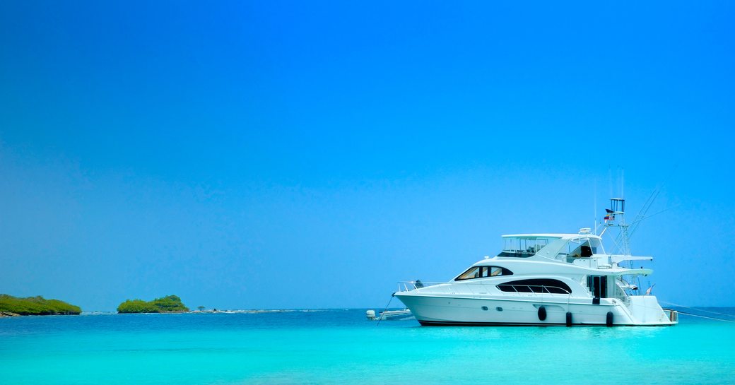 Small motor yacht anchored in blue waters of Florida