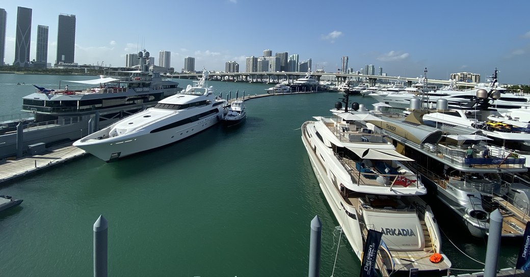 the luxury motor yacht Bella Vita berthed on the sunny marina of the 2020 miami yacht show in Florida