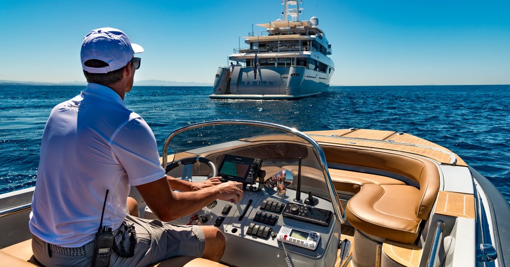 aft view of superyacht RARITY with her tender approaching on a Mediterranean yacht charter