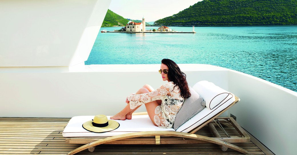 charter guest relaxes on a lounger while cruising in Montenegro 