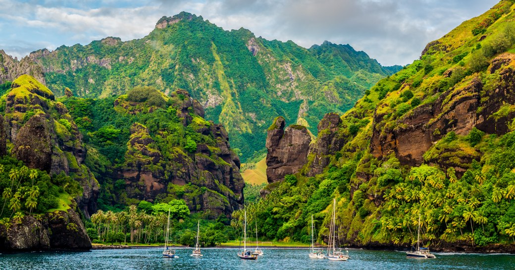 yachts anchored in French Polynesian island, Marquesas