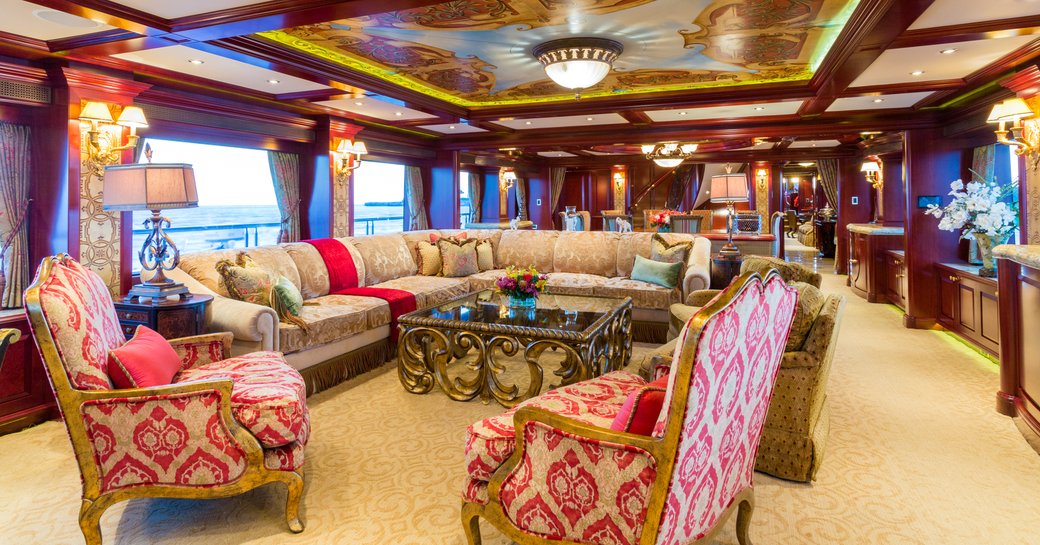 opulently styled main salon with hand-painted murals on the ceiling on board charter yacht Amarula Sun 