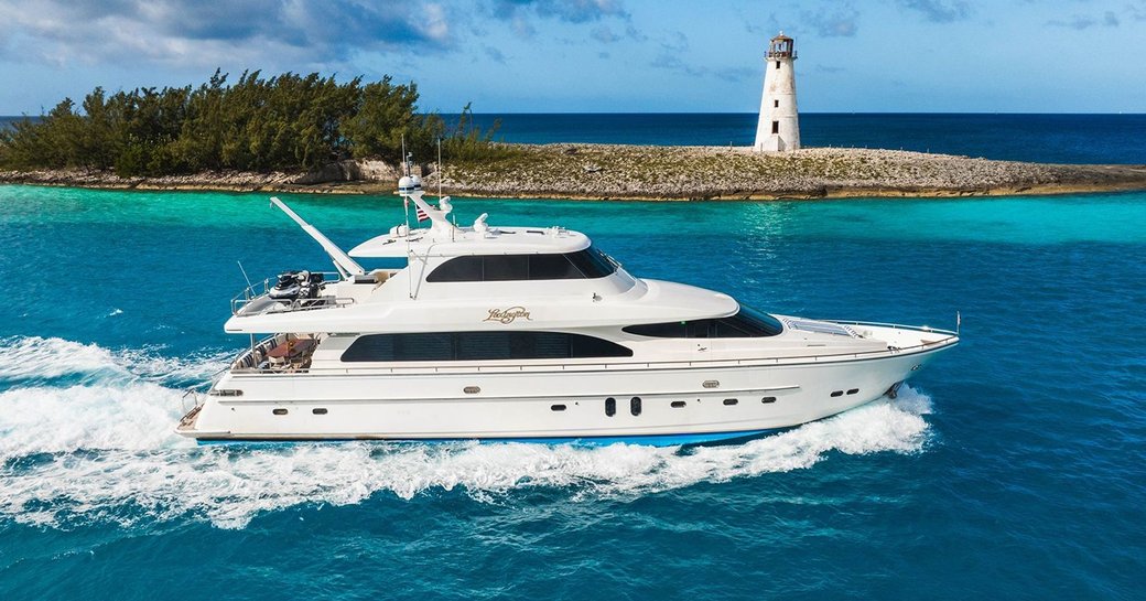 Side view of charter yacht LEXINGTON at sea with lighthouse