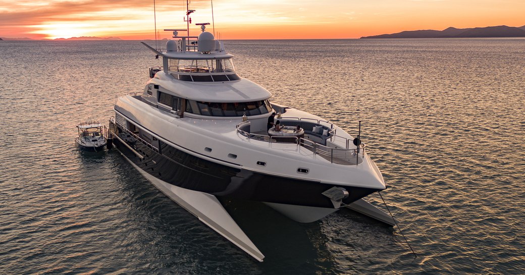 superyacht SPIRIT anchored on a luxury yacht charter in the South Pacific at sunset