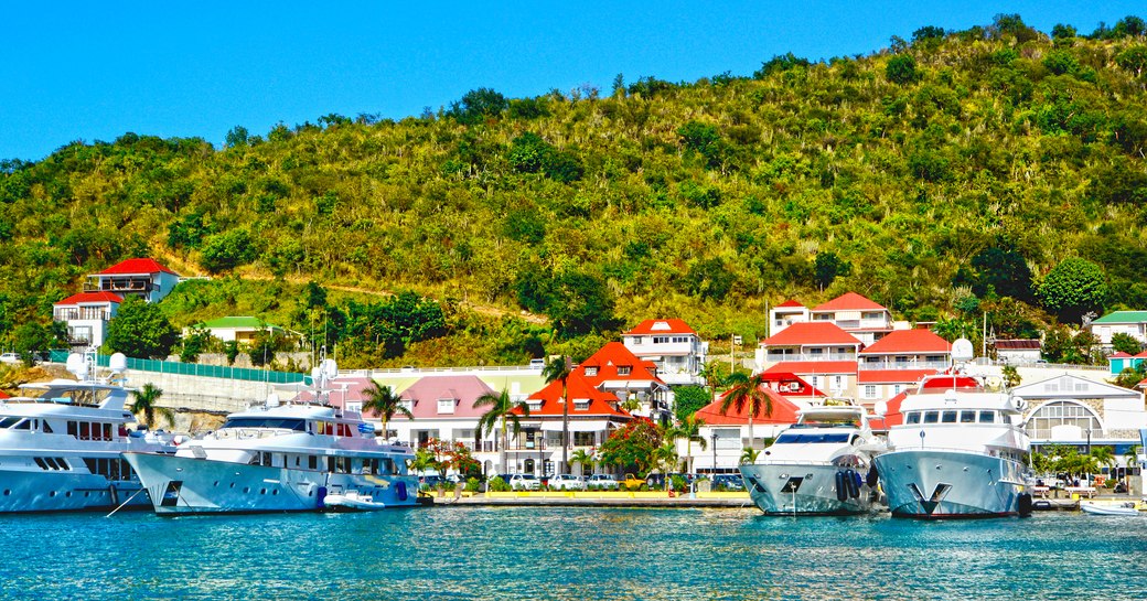 Ground-level view of St Barts Gustavia Harbor with motor yacht charters berthed