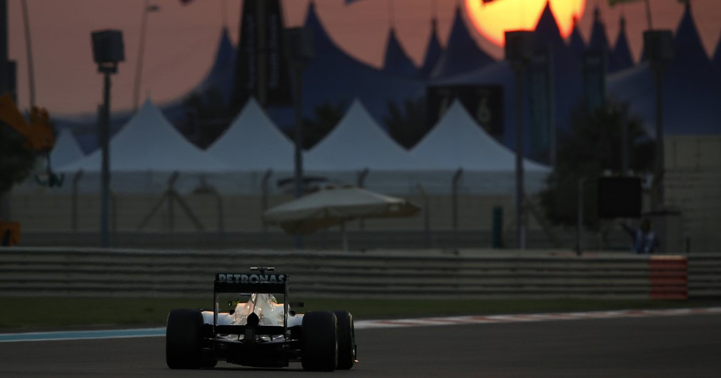 Formula one car racing at sunset in Dubai