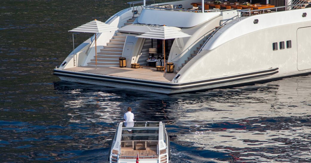 Swim platform and approaching tender onboard charter yacht PLAN B