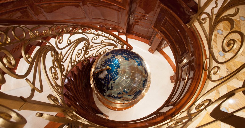Globe figure positioned at the bottom of the spiral staircase 
