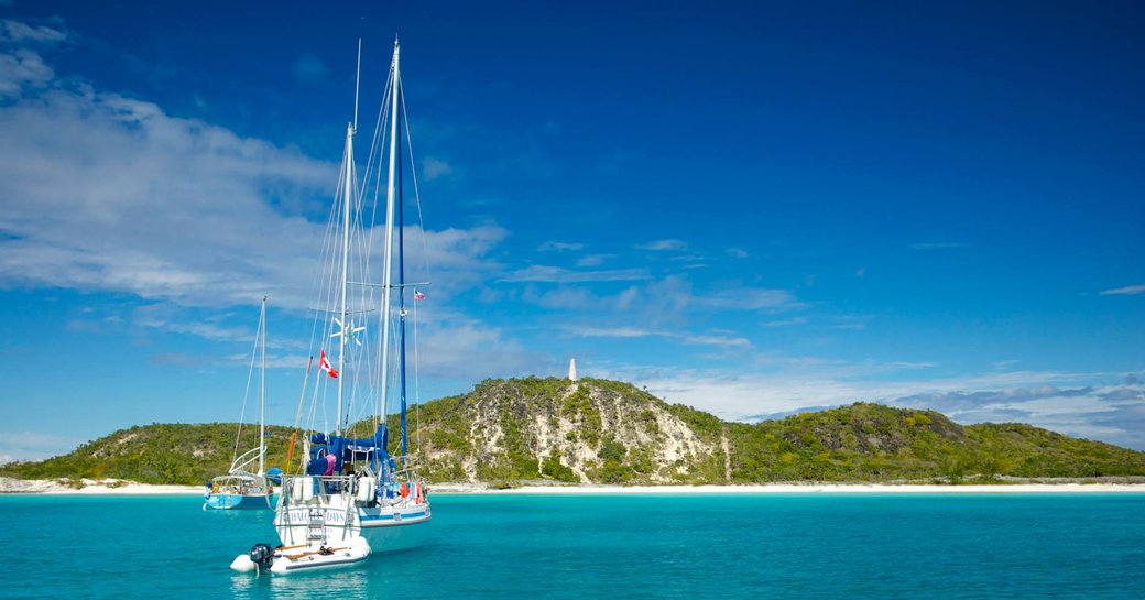 A sailing yacht approaches an island in the Bahamas