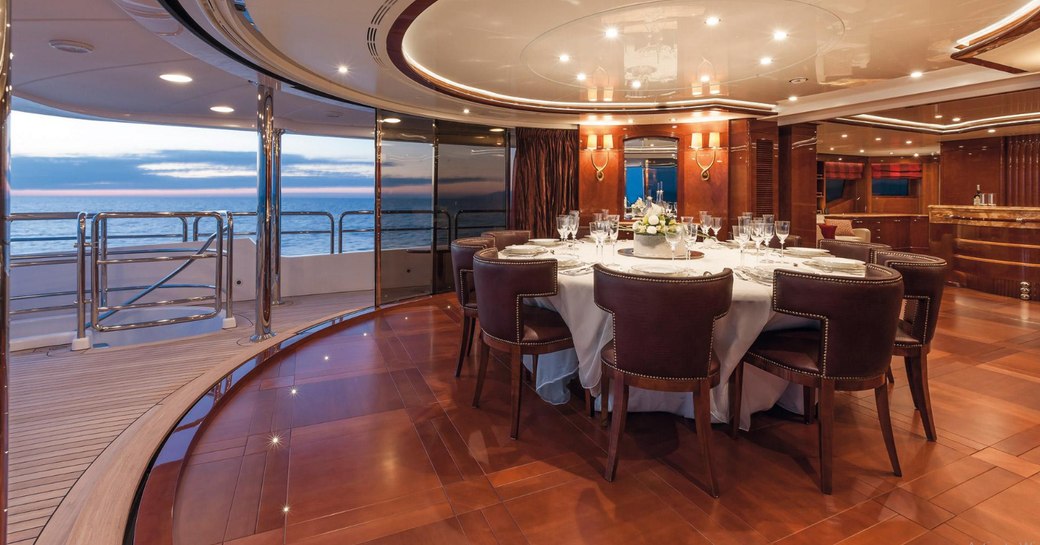 indoor-outdoor dining area on the upper deck aft of superyacht CHECKMATE 