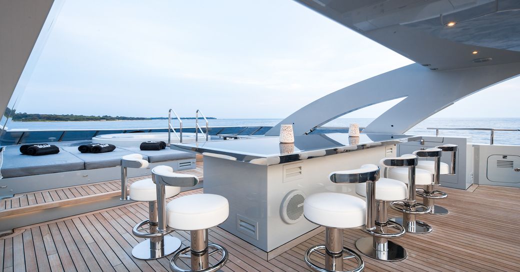 bar and sunken spa pool surrounded by sun pads on the sundeck of luxury yacht BLISS 