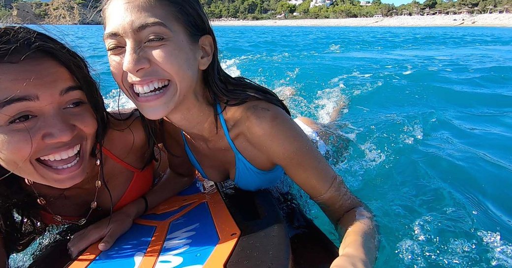 Kids enjoying a Wave Jam surfboard on the water