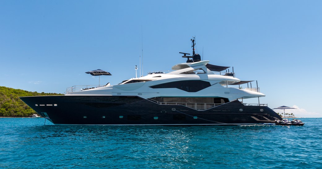 superyacht Take 5 anchors on a luxury yacht charter with drop-down swim platform lowered 