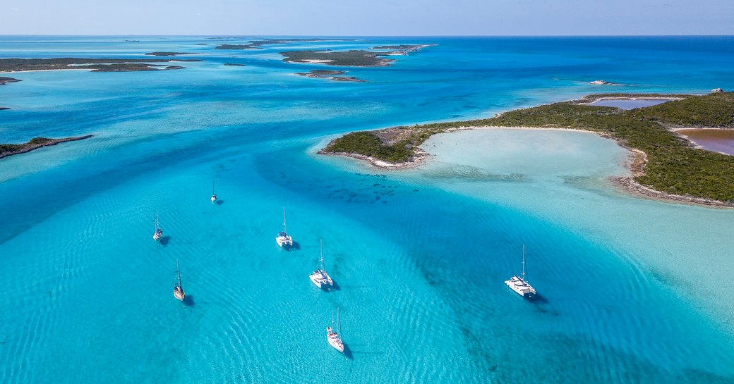 Yachts in clear waters of Exumas in Bahamas