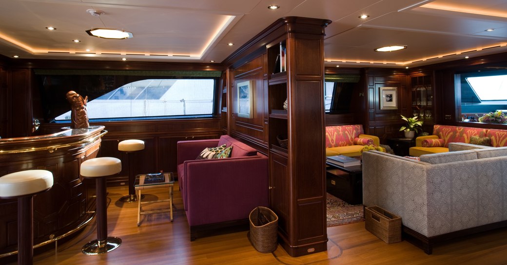 bar and lounge area made up of three sofas in the main salon of superyacht BLUSH 