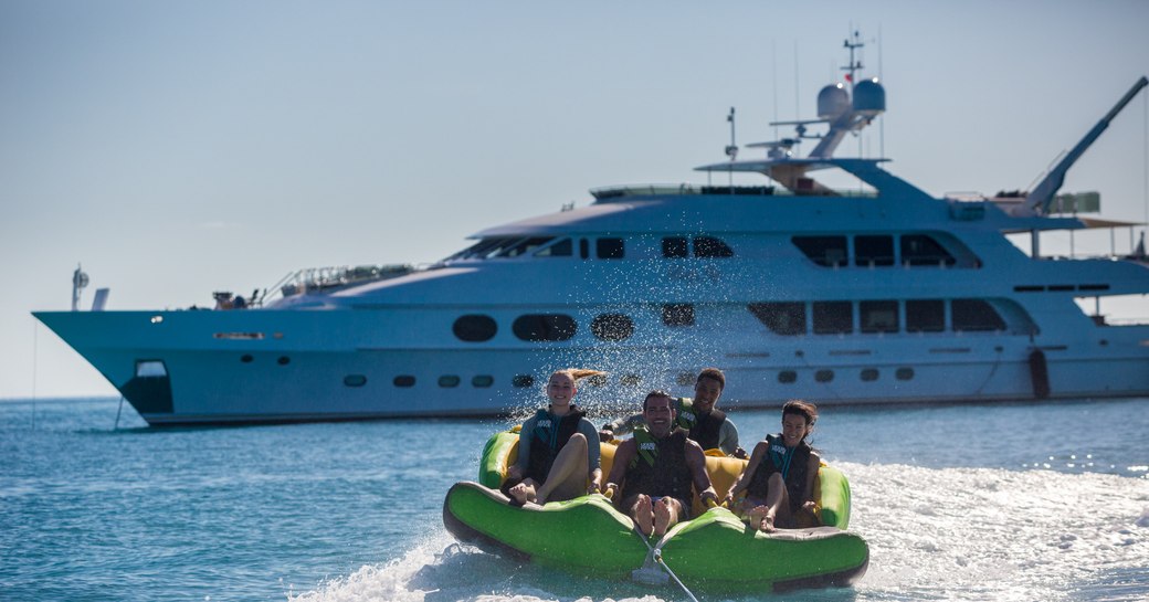 charter guests get out on the towable toys with superyacht Lady Joy in the background