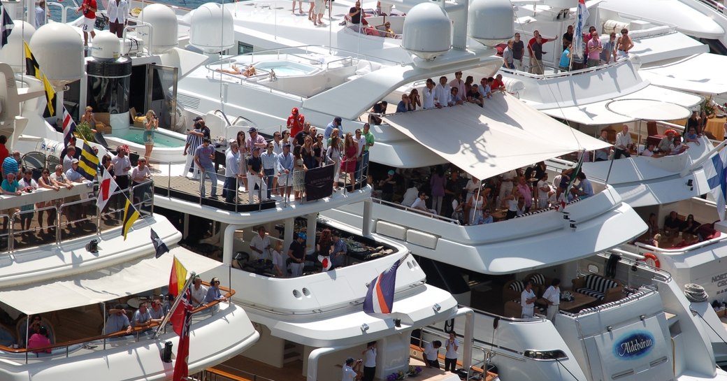 crowds gather on superyachts lined-up trackside at the Monaco Grand Prix